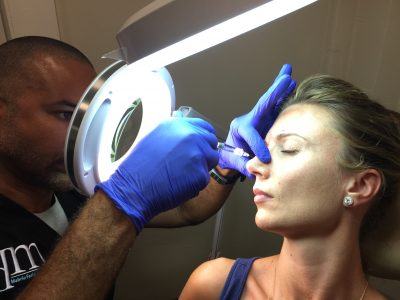 Dr. Mabrie performing nonsurgical rhinoplasty procedure on patient