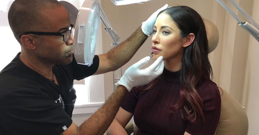 Dr. Mabrie examining patient's face.