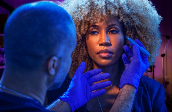 Dr. Mabrie examining a patient's face