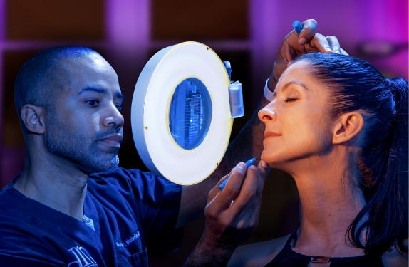 Dr. Mabrie marking a woman's face with a marker