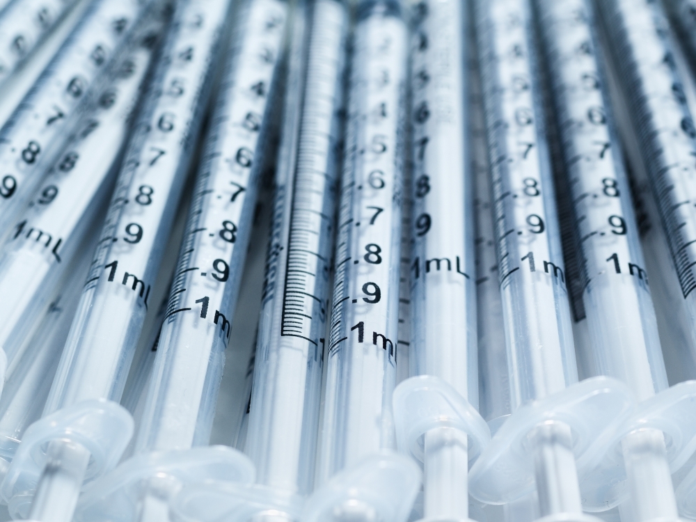 a stack of dermal filler syringes